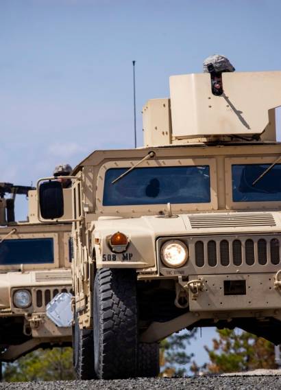 U.S. Army Soldiers with the 253rd Transportation Company, New Jersey Army National Guard, prepare to enter a simulated village in Humvees during the Company's annual evaluation at Joint Base McGuire-Dix-Lakehurst, N.J., April 8, 2019. The Cape May-based Soldiers were evaluated by 1st Army Soldiers from the 1-315th Brigade Support Battalion, 174th Infantry Brigade, on numerous combat tasks including reacting to a chemical threat and improvised explosive devices, evacuating casualties while under fire, and recovering disabled vehicles. (New Jersey National Guard photo by Mark C. Olsen). Original public domain image from Flickr